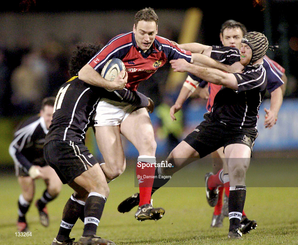 27 February 2004; Jason Jones Hughes of Munster is tackled by Elvis Seveali'i of Neath Swansea Ospreys during the Celtic League match between Munster and Neath Swansea Ospreys at Musgrave Park in Cork. Photo by Damien Eagers/Sportsfile
