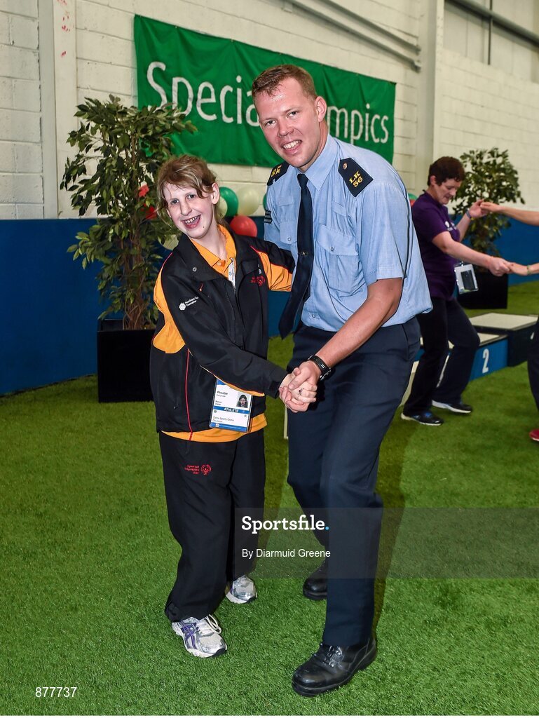 14 June 2014; Bocce athlete Phoebe Dalrymple, Ballymena, Co. Antrim, Team Ulster, dances with Garda Dermot Keating, from Henry St Garda Station, Limerick, after a medal ceremony. Special Olympics Ireland Games, Delta Sports Dome, Limerick. Picture credit: Diarmuid Greene / SPORTSFILE