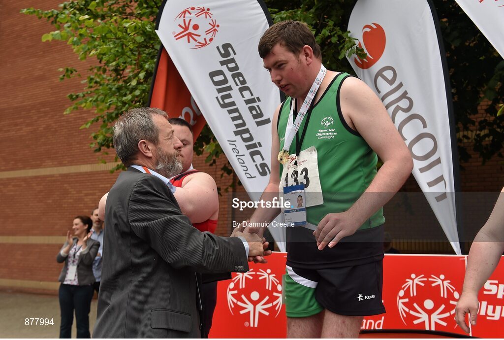 14 June 2014; Damien McDonnell, Swinford, Co. Mayo, Team Connaught, is presented with his gold medal by Sean Kelly MEP after the Division 2 Mens 800m walk final. Special Olympics Ireland Games, University of Limerick, Limerick. Picture credit: Diarmuid Greene / SPORTSFILE