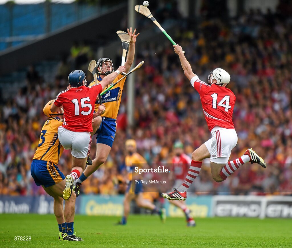 15 June 2014; The Cork captain Patrick Cronin, supported by Patrick Horgan, wins possession ahead of Clare defenders Brendan Bugler and Cian Dillon. Munster GAA Hurling Senior Championship, Semi-Final, Clare v Cork, Semple Stadium, Thurles, Co. Tipperary. Picture credit: Ray McManus / SPORTSFILE