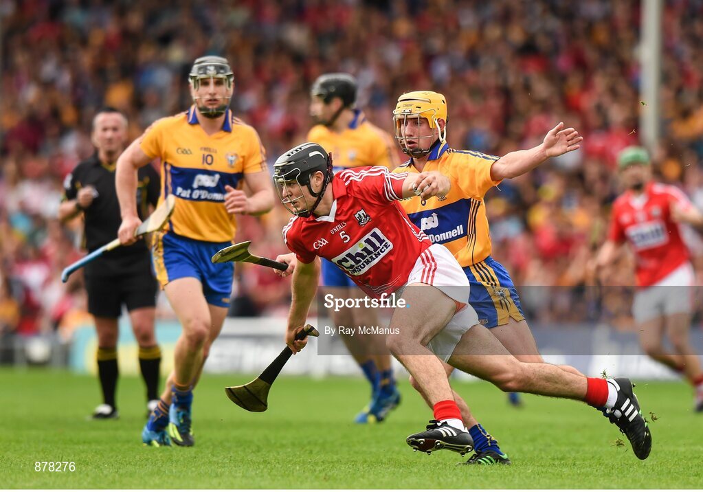 15 June 2014; Christopher Joyce, Cork, prepares to clear under pressure from Clare's Colm Galvin. Munster GAA Hurling Senior Championship, Semi-Final, Clare v Cork, Semple Stadium, Thurles, Co. Tipperary. Picture credit: Ray McManus / SPORTSFILE