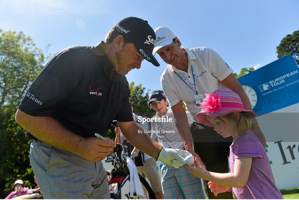 18 June 2014; Julie Anne Creen, age 3, from Dripsey, Co. Cork, receives a signed ball from Graeme McDowell at the 18th tee box during the 2014 Irish Open Golf Championship Pro-Am. Fota Island, Cork. Picture credit: Diarmuid Greene / SPORTSFILE