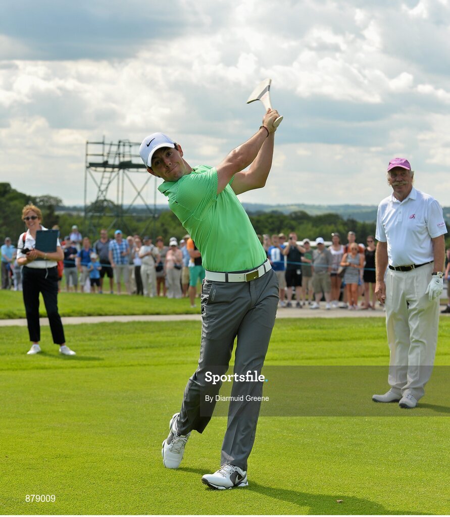 18 June 2014; Rory McIlroy, watched by playing partner Dermot Desmond, after hitting a golf ball with a hurley on the 9th fairway during the 2014 Irish Open Golf Championship Pro-Am. Fota Island, Cork. Picture credit: Diarmuid Greene / SPORTSFILE