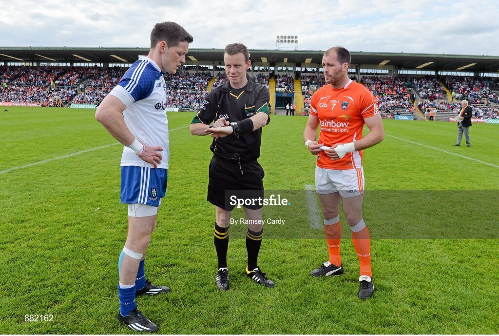 28 June 2014; Referee Joe McQuillan performs the pre-match coin toss in the company of Monaghan captain Conor McManus and Armagh captain Ciaran McKeever. Ulster GAA Football Senior Championship, Semi-Final, Armagh v Monaghan, St Tiernach's Park, Clones, Co. Monaghan. Picture credit: Ramsey Cardy / SPORTSFILE
