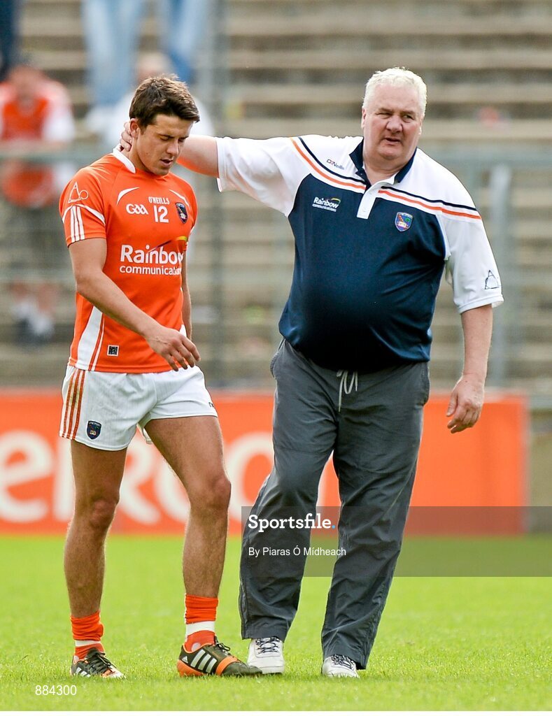 6 July 2014; Armagh manager Paul Grimley consoles Stefan Campbell as he leaves the field after being sent off for a black card offence. Ulster GAA Football Senior Championship, Semi-Final Replay, Armagh v Monaghan, St Tiernach's Park, Clones, Co. Monaghan. Picture credit: Piaras Ó Mídheach / SPORTSFILE