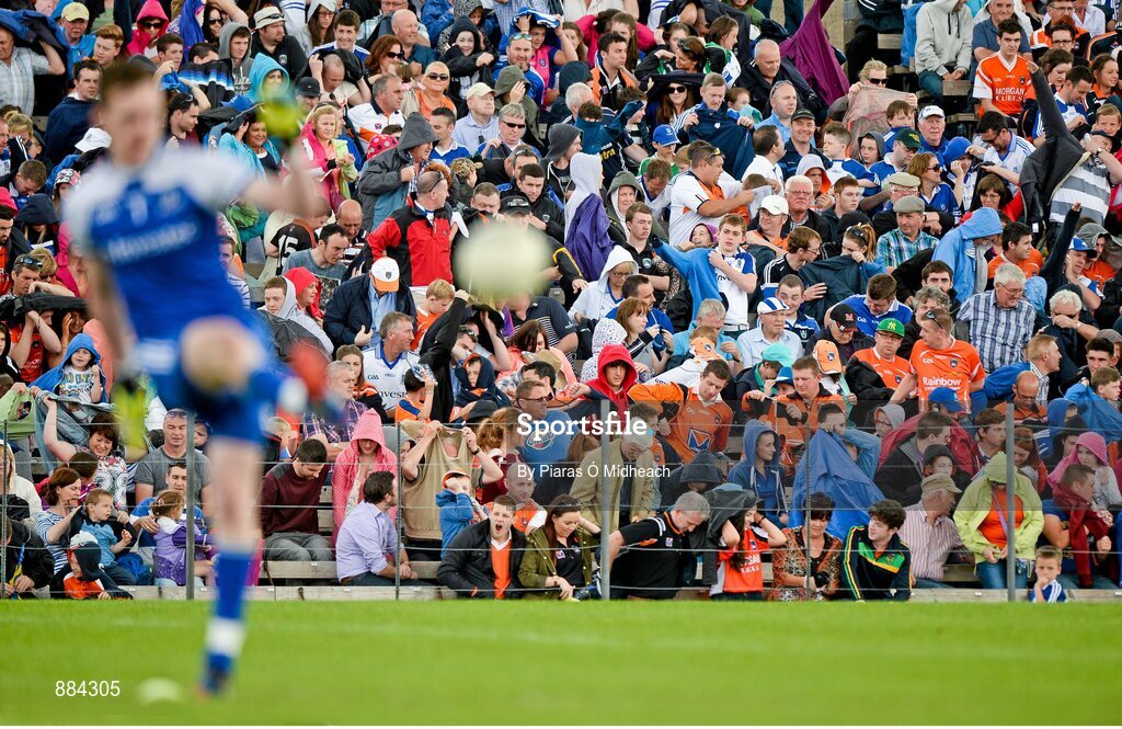 6 July 2014; Spectators shelter from the rain during the match. Ulster GAA Football Senior Championship, Semi-Final Replay, Armagh v Monaghan, St Tiernach's Park, Clones, Co. Monaghan. Picture credit: Piaras Ó Mídheach / SPORTSFILE