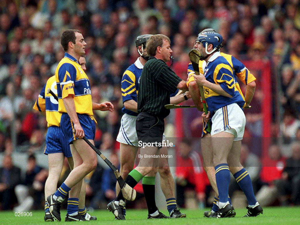 12 June 1999; Referee Dickie Murphy separates John Leahy of Tipperary and Anthony Daly of Clare during the Munster Senior Hurling Championship Semi final Replay match between Clare v Tipperary at Páirc Uí Chaoimh in Cork. Photo by Brendan Moran/Sportsfile