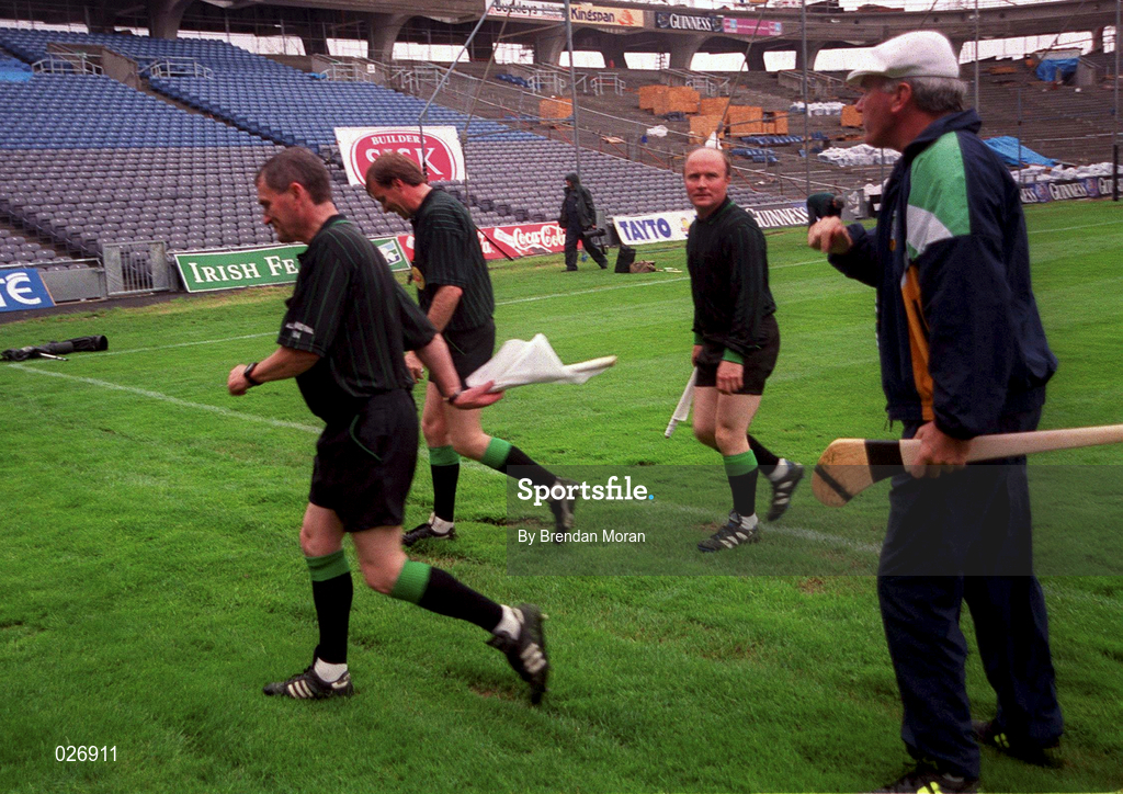 8 August 1999; Offaly manager Michael Bond, right, attempts to have a word with Referee Dickie Murphy, 2nd from left, as he and his linesmen leave the field at half time during the Guinness All-Ireland Hurling Senior Championship Semi-Final match between Cork and Offaly at Croke Park in Dublin. Photo by Brendan Moran/Sportsfile