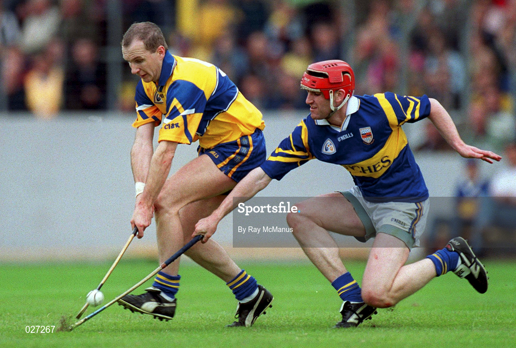 12 June 1999;  Liam Doyle of Clare in action against Eddie Tucker of Tipperary during the Munster Senior Hurling Championship Semi final Replay match between Clare v Tipperary at Páirc Uí Chaoimh in Cork. Photo by Ray McManus/Sportsfile