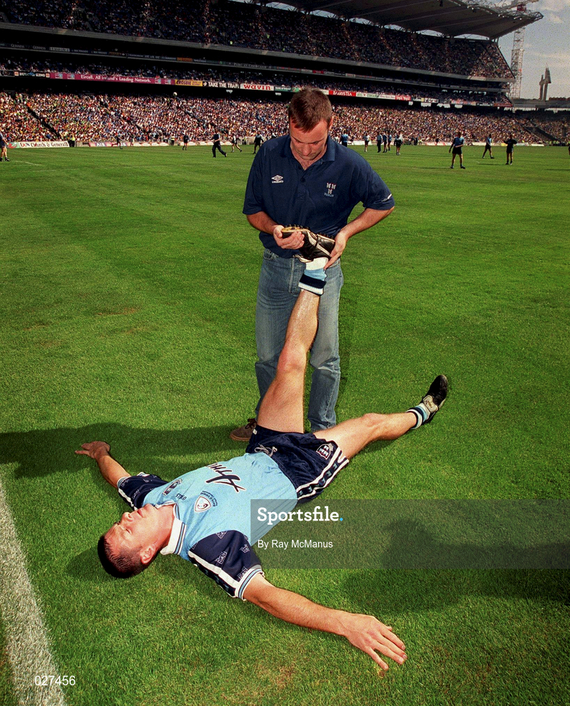1 August 1999; Paddy Moran of Dublin is assisted in stretching exercises before the ahead of the Bank of Ireland Leinster Senior Football Championship Final match between Dublin and Meath at Croke Park in Dublin. Photo by Ray McManus/Sportsfile