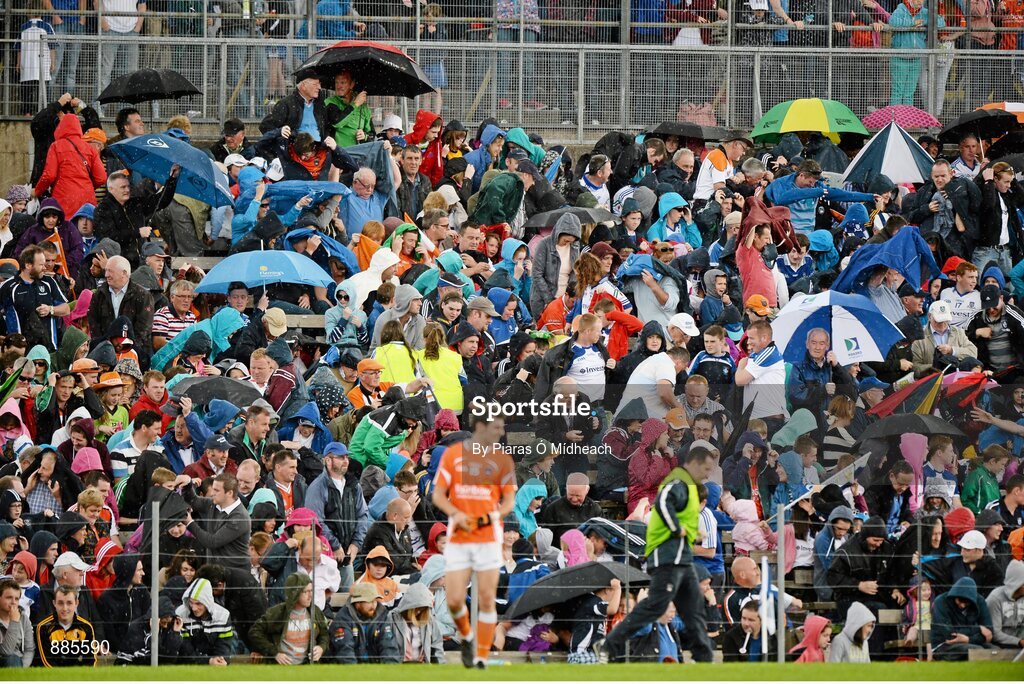 6 July 2014; Spectators shelter from the rain during the match. Ulster GAA Football Senior Championship, Semi-Final Replay, Armagh v Monaghan, St Tiernach's Park, Clones, Co. Monaghan. Picture credit: Piaras Ó Mídheach / SPORTSFILE