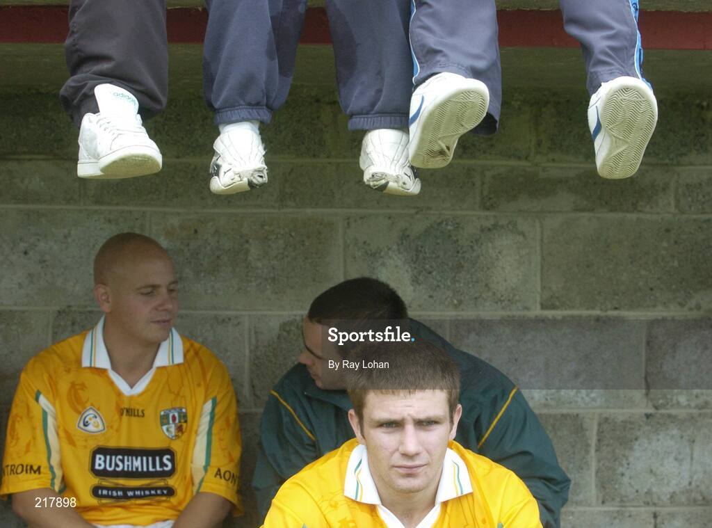 12 August 2006; Antrim's Anthony Scullion watches the game after been substituted as some fans sit above. Tommy Murphy Cup, Semi-Final, Louth v Antrim, St. Brigid's Park, Dowdallshill, Dundalk, Co. Louth. Picture credit; Ray Lohan / SPORTSFILE *** Local Caption ***
