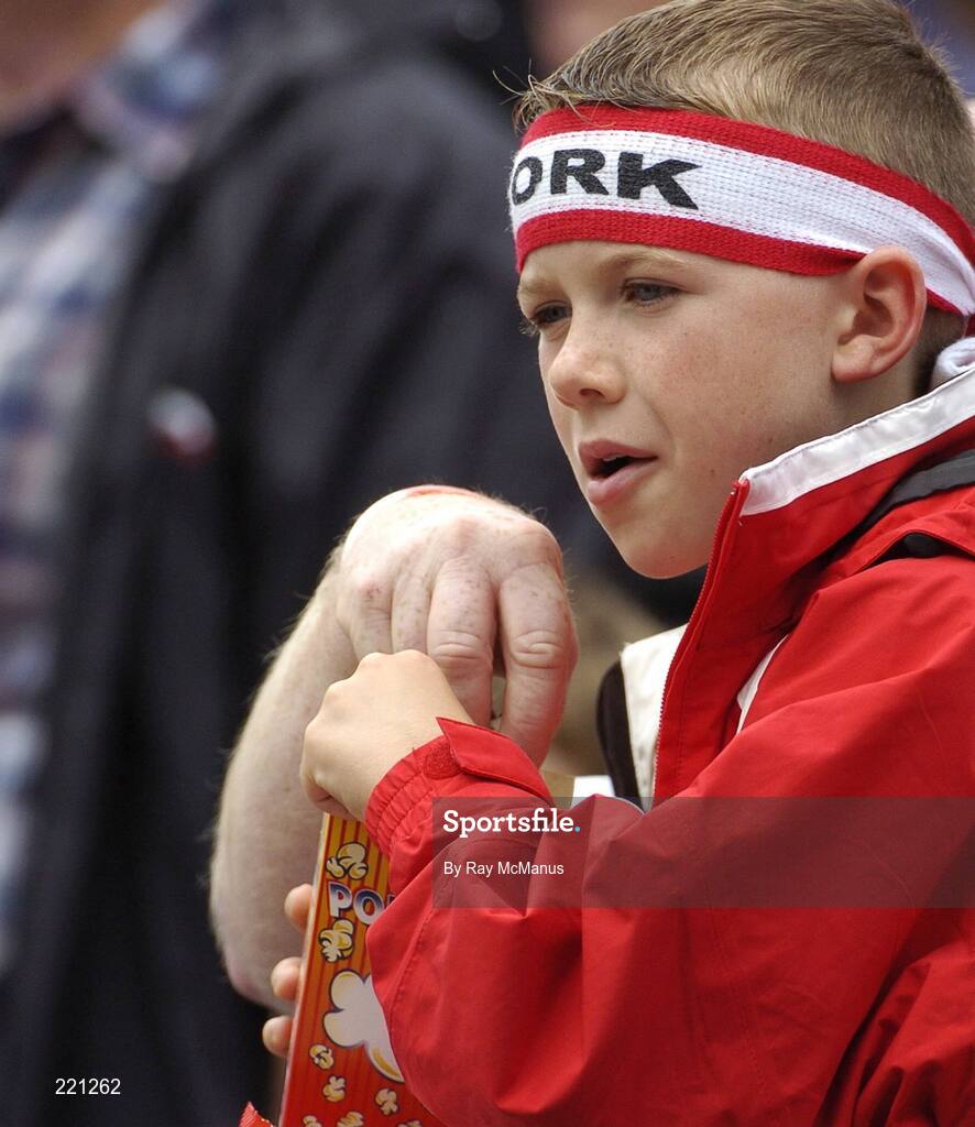3 September 2006; A young Cork supporter, and his guardian, tuck into a packet of popcorn. Guinness All-Ireland Senior Hurling Championship Final, Cork v Kilkenny, Croke Park, Dublin. Picture credit: Ray McManus / SPORTSFILE