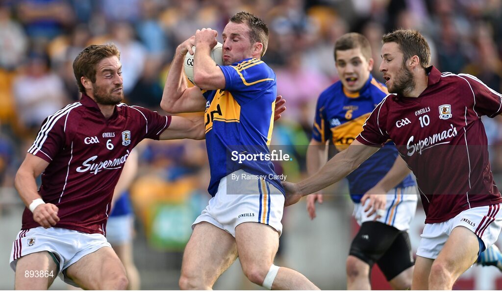 26 July 2014; Peter Acheson, Tipperary, in action against Gary O'Donnell, left, and Michael Lundy, Galway. GAA Football All Ireland Senior Championship, Round 4A, Galway v Tipperary. O'Connor Park, Tullamore, Co. Offaly. Picture credit: Ramsey Cardy / SPORTSFILE