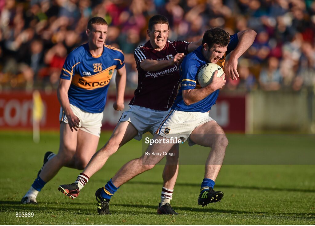 26 July 2014; Barry Grogan, Tipperary, with support from team-mate Ian Fahey, in action against Paul Varley, Galway. GAA Football All Ireland Senior Championship, Round 4A, Galway v Tipperary. O'Connor Park, Tullamore, Co. Offaly. Picture credit: Barry Cregg / SPORTSFILE