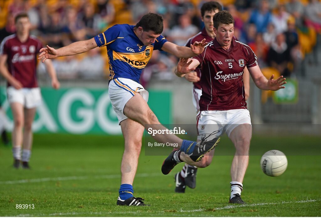 26 July 2014; Colin O'Riordan, Tipperary, shoots to score his side's third goal of the game despite the challenge from Gareth Bradshaw, Galway. GAA Football All Ireland Senior Championship, Round 4A, Galway v Tipperary. O'Connor Park, Tullamore, Co. Offaly. Picture credit: Barry Cregg / SPORTSFILE