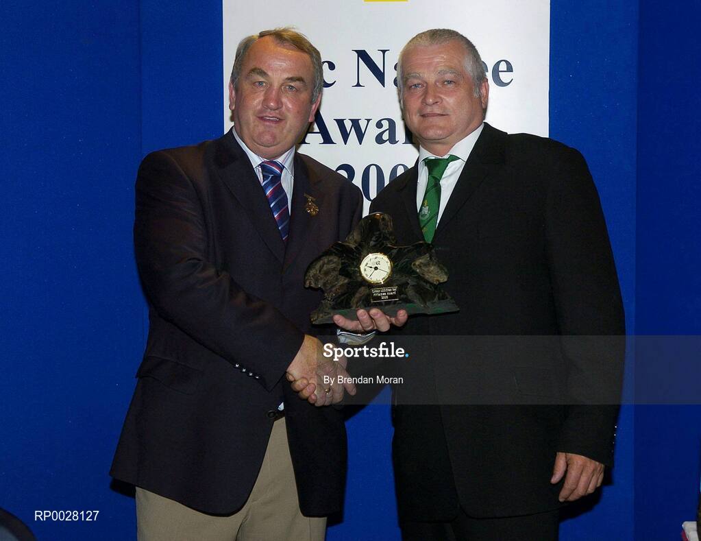 15 July 2006; Ciaran Crilly, Castlewellan, Co. Down, receives his GAA MacNamee award for "Best Club Media Presentation" on behalf of his club Castlewellan, from GAA President Nickey Brennan at the 2006 GAA MacNamee awards. Burlington Hotel, Dublin. Picture credit: Brendan Moran / SPORTSFILE
