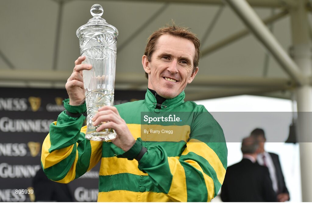 31 July 2014; Jockey Tony McCoy holds up the winning trophy after rode Thomas Edison to victory in the Guinness Galway Hurdle Handicap. Galway Racing Festival, Ballybrit, Co. Galway. Picture credit: Barry Cregg / SPORTSFILE