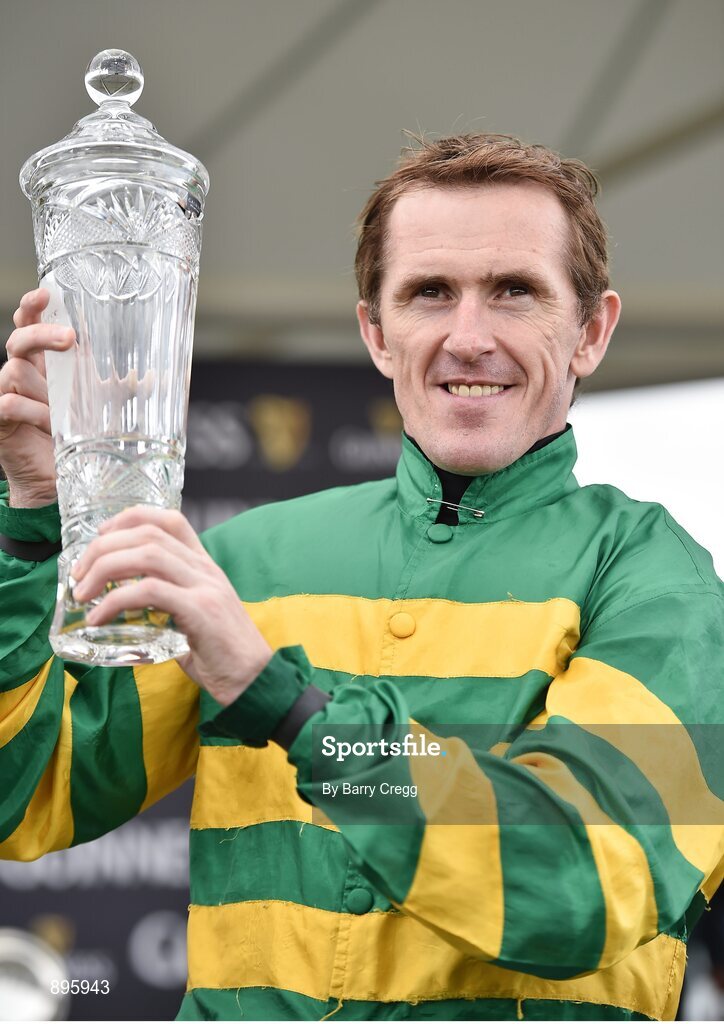 31 July 2014; Jockey Tony McCoy holds up the winning trophy after rode Thomas Edison to victory in the Guinness Galway Hurdle Handicap. Galway Racing Festival, Ballybrit, Co. Galway. Picture credit: Barry Cregg / SPORTSFILE