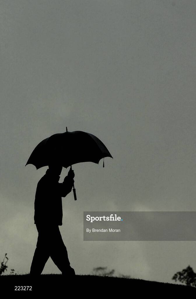 23 September 2006; A golf marshall takes shelter from the rain during Saturday morning's four-ball matches. 36th Ryder Cup Matches, K Club, Straffan, Co. Kildare, Ireland. Picture credit: Brendan Moran / SPORTSFILE