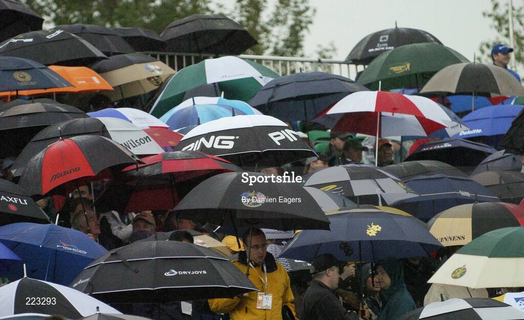 23 September 2006; Golf fans shelter from the heavy showers during Saturday morning's four-ball matches. 36th Ryder Cup Matches, K Club, Straffan, Co. Kildare, Ireland. Picture credit: Damien Eagers / SPORTSFILE