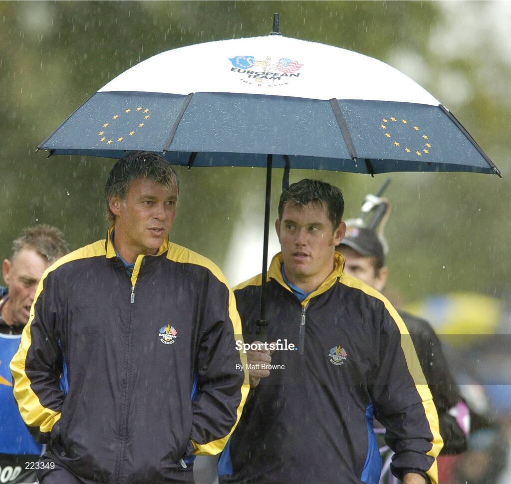 23 September 2006; Team Europe 2006 playing partners Darren Clarke, left, and Lee Westwood under an umbrella during Saturday morning's four-ball matches. 36th Ryder Cup Matches, K Club, Straffan, Co. Kildare, Ireland. Picture credit: Matt Browne / SPORTSFILE