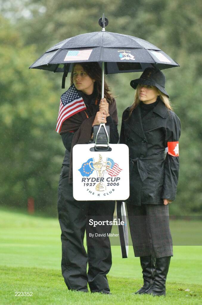 23 September 2006; Amy DiMarco, left, and Amy Mickelson, wives of Team USA 2006 players Chris DiMarco and Phil Mickelson, shelter from the rain during Saturday morning's four-ball matches. 36th Ryder Cup Matches, K Club, Straffan, Co. Kildare, Ireland. Picture credit: David Maher / SPORTSFILE