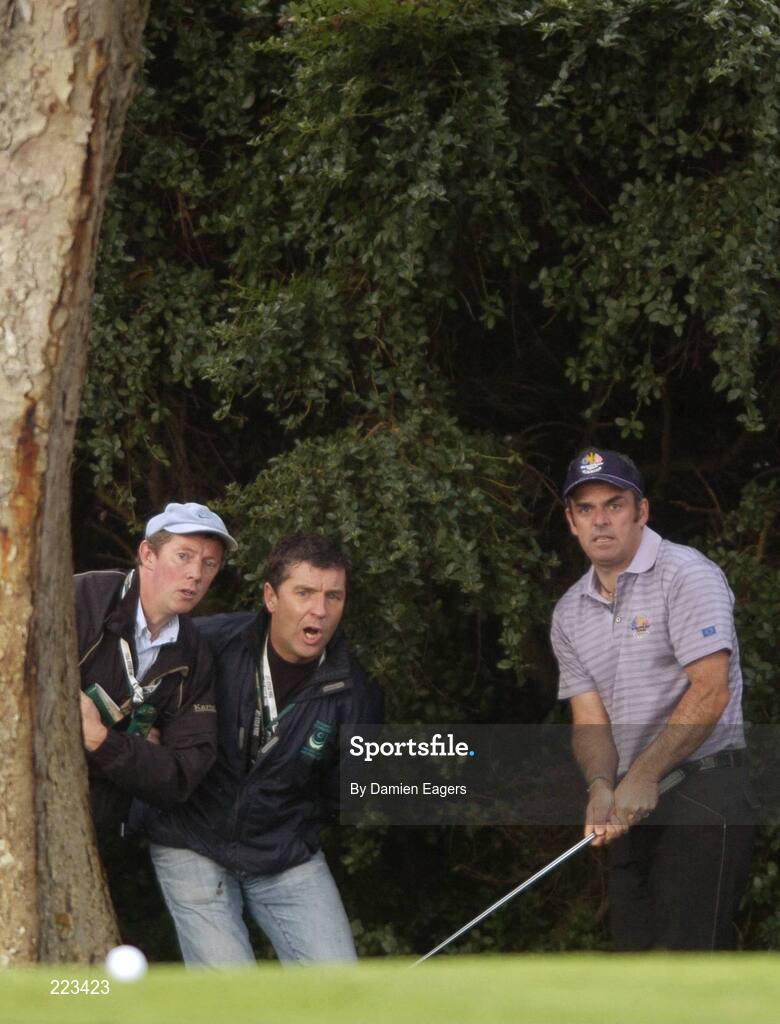 23 September 2006; Paul McGinley, Team Europe 2006, with two supporters watches his chip from the rough on the ninth hole during Saturday afternoon's foursomes matches. 36th Ryder Cup Matches, K Club, Straffan, Co. Kildare, Ireland. Picture credit: Damien Eagers / SPORTSFILE