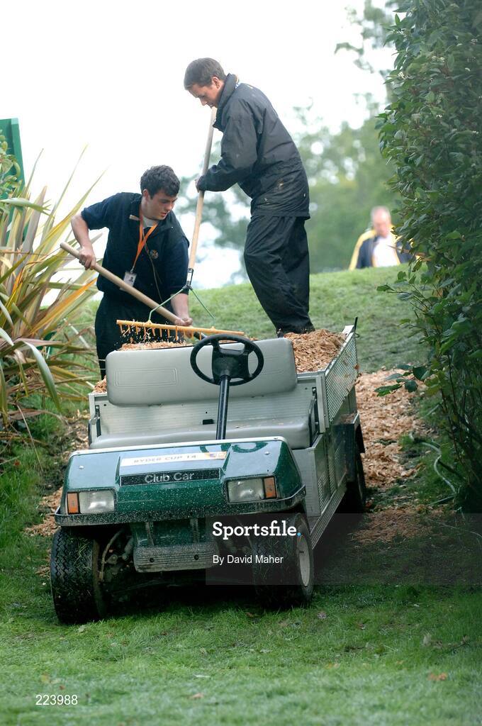 23 September 2006; Greenkeepers put wood chippings on the pathways for the public during heavy rain during Saturday afternoon's foursomes matches. 36th Ryder Cup Matches, K Club, Straffan, Co. Kildare, Ireland. Picture credit: David Maher / SPORTSFILE