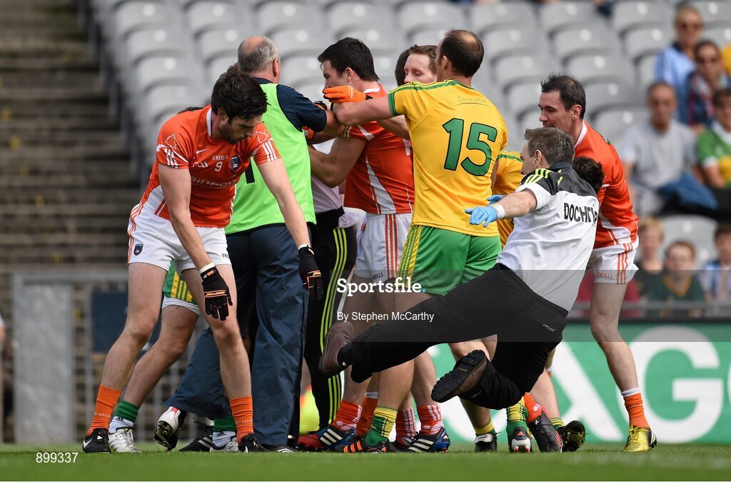 9 August 2014; Aaron Findon, Armagh, pushes Donegal team doctor Kevin Moran during an altercation in the first half. GAA Football All-Ireland Senior Championship, Quarter-Final, Donegal v Armagh, Croke Park, Dublin. Picture credit: Stephen McCarthy / SPORTSFILE