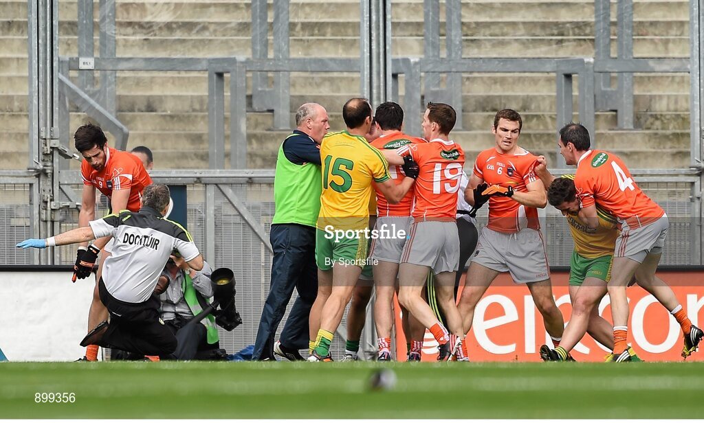 9 August 2014; Aaron Findon, Armagh, far left, pushes Donegal team doctor Kevin Moran during an altercation in the first half. GAA Football All-Ireland Senior Championship, Quarter-Final, Donegal v Armagh, Croke Park, Dublin. Photo by Sportsfile