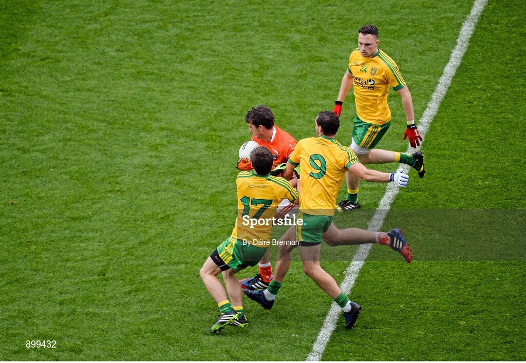 9 August 2014; Ethan Rafferty, Armagh, in action against Donegal players, left to right, Darach O'Connor, Odhrán Mac Niallais, and Martin McElhinney. GAA Football All-Ireland Senior Championship, Quarter-Final, Donegal v Armagh, Croke Park, Dublin. Picture credit: Dáire Brennan / SPORTSFILE
