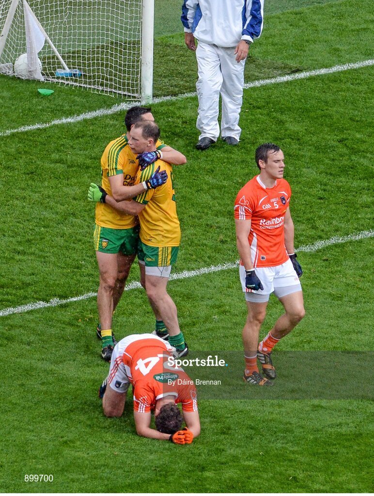 9 August 2014; Rory Kavanagh, left, and Anthony Thompson, Donegal, celebrate, while Ethan Rafferty, Armagh, falls to the ground at the final whistle. GAA Football All-Ireland Senior Championship, Quarter-Final, Donegal v Armagh, Croke Park, Dublin. Picture credit: Dáire Brennan / SPORTSFILE