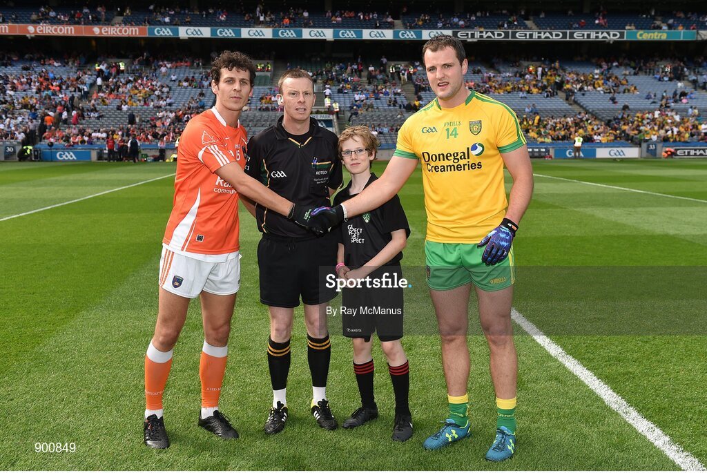 9 August 2014; Donegal captain Michael Murphy shakes hands with Armagh captain Jamie Clarke. with referee Joe McQuillan, and Dara McCarthy, aged 13, from Na Fianna GAA Club. GAA Football All-Ireland Senior Championship, Quarter-Final, Donegal v Armagh, Croke Park, Dublin. Picture credit: Ray McManus / SPORTSFILE