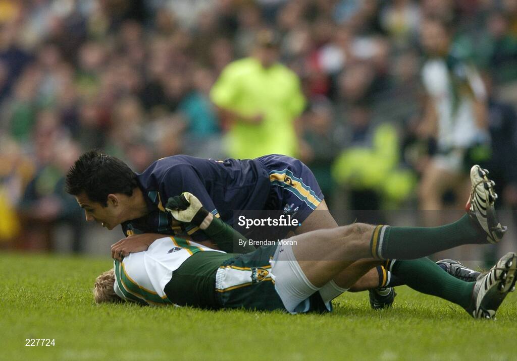 5 November 2006; Graham Geraghty, Ireland, is tackled by Danyle Pearse, Australia, before being stretchered off with an injury as a result of this tackle. Coca-Cola International Rules Series 2006, Second Test, Ireland v Australia, Croke Park, Dublin. Picture credit: Brendan Moran / SPORTSFILE