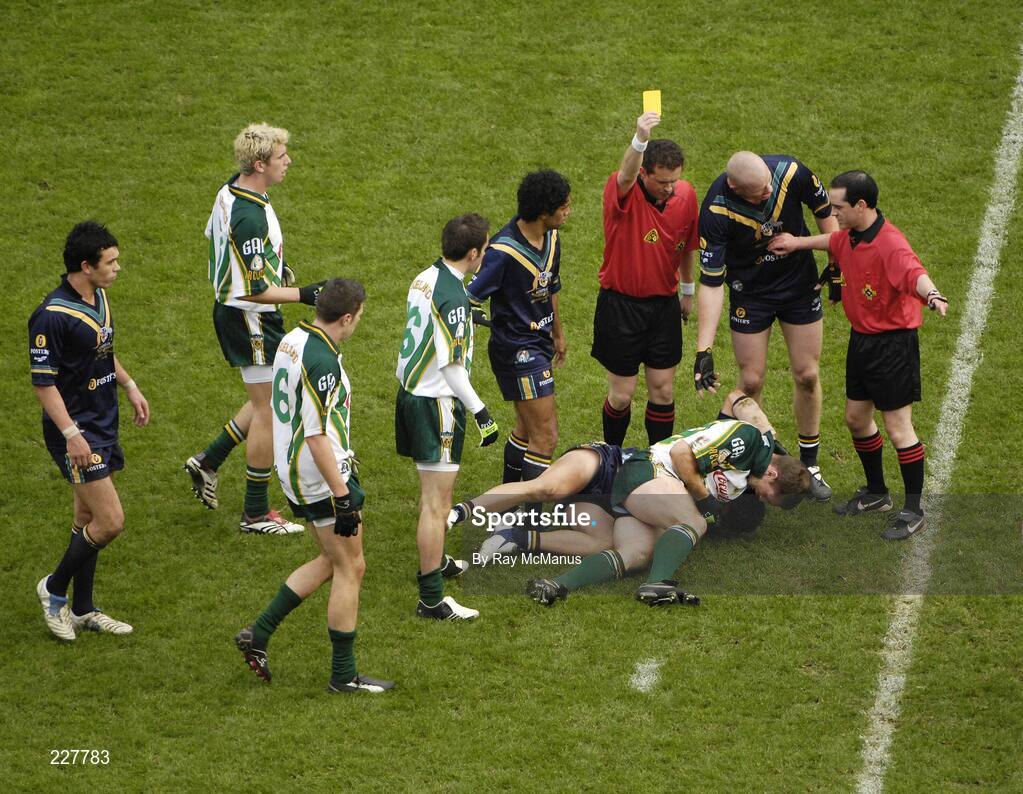 5 November 2006; Australian referee Shane McInerney, left, stands over Brett Peake, Australia, and Kieran McGeeney, Ireland, with a yellow card for each. Coca-Cola International Rules Series 2006, Second Test, Ireland v Australia, Croke Park, Dublin. Picture credit: Ray McManus / SPORTSFILE