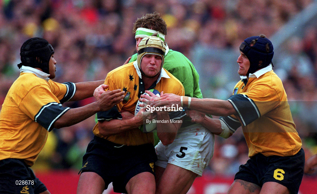 10 October 1999; David Griffin of Australia, centre, supported by team-mates Toutai Kefu, left, and Mark Connors is tackled by Malcolm O'Kelly of Ireland during the Rugby World Cup Pool E match between Ireland and Australia at Lansdowne Road in Dublin. Photo by Brendan Moran/Sportsfile