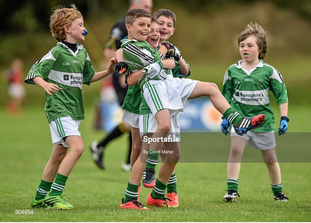 24 August 2014; Ross Finnegan, second from left and Eoin O'Hanlon, Monaghan Town, Co.Monaghan, representing Ulster celebrate with their team-mate's at the end of the Gaellc football Mixed U.10 playoff final against Clane/Rathcoffey, Co.Kildare, representing Leinster. HSE Community Games August Festival 2014, Athlone Institute of Technology, Athlone, Co. Westmeath.  Picture credit: David Maher / SPORTSFILE