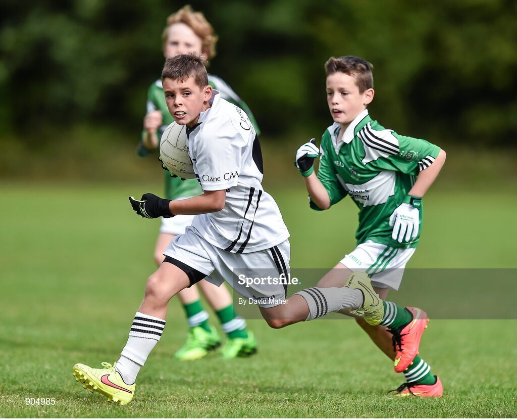 24 August 2014; Callum Doran, Clane/Rathcoffey, Co.Kildare, representing Leinster in action against Eoin O'Hanlon, Monaghan Town, Co.Monaghan, representing Ulster, in the playoff of the Gaelic Football Mixed Under 10 final. HSE Community Games August Festival 2014, Athlone Institute of Technology, Athlone, Co. Westmeath.  Picture credit: David Maher / SPORTSFILE