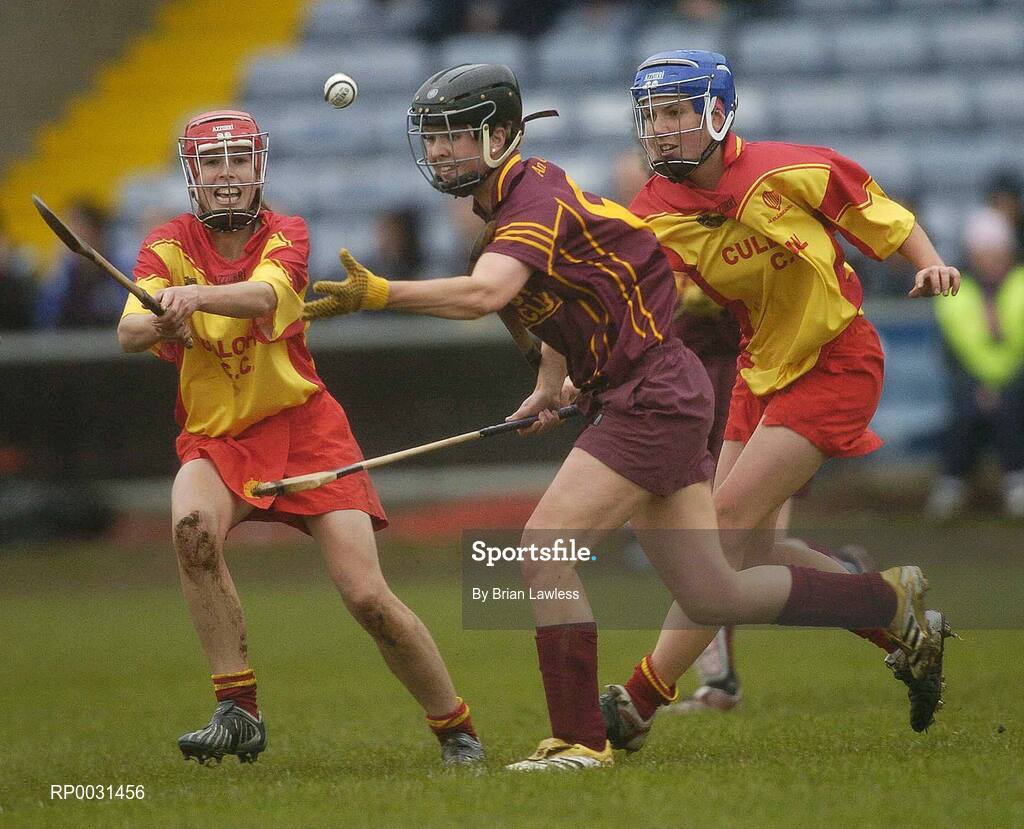 19 November 2006; Katrina Kinsella, Keady, in action against Louise Mahony, left, and Elaine Mahony, Harps. All-Ireland Junior Camogie Championship Final, Harps v Keady, O'Moore Park, Portlaoise, Co. Laois. Picture credit: Brian Lawless / SPORTSFILE