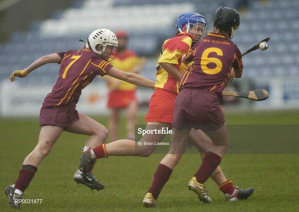 19 November 2006; Angela Hanlon, Harps, in action against Roisin Murray, left, and Katrina Kinsella, Keady. All-Ireland Junior Camogie Championship Final, Harps v Keady, O'Moore Park, Portlaoise, Co. Laois. Picture credit: Brian Lawless / SPORTSFILE
