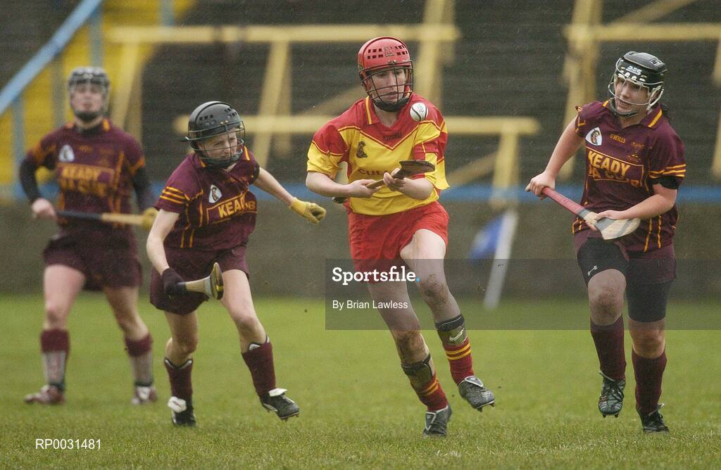 19 November 2006; Laura Mahony, Harps, in action against Patricia McCabe, left, and Kelly Ann Hughes, Keady. All-Ireland Junior Camogie Championship Final, Harps v Keady, O'Moore Park, Portlaoise, Co. Laois. Picture credit: Brian Lawless / SPORTSFILE