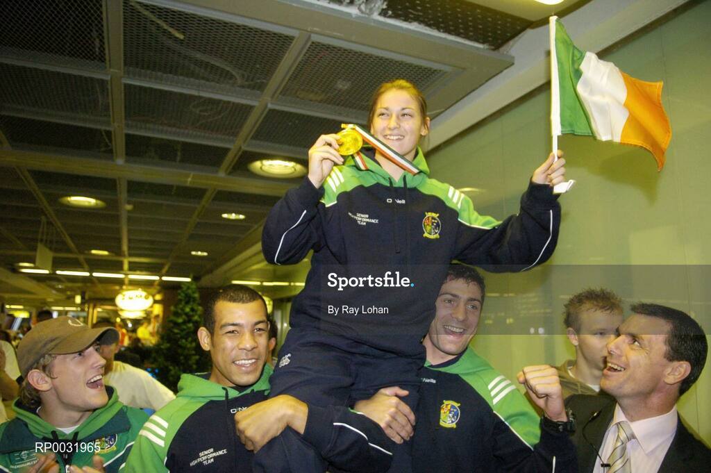 25 November 2006; Katie Taylor, celebrates with her team-mates at Dublin airport after arriving home from the Fourth Women's World Championships, where she was crowned World Champion. Dublin Airport, Dublin. Picture credit: Ray Lohan / SPORTSFILE