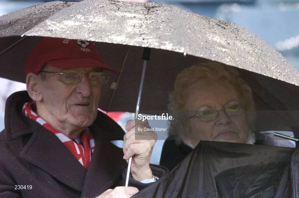 3 December 2006; Two Derry City supporters shelter from the rain during the game. FAI Carlsberg Senior Challenge Cup Final, Derry City v St Patrick's Athletic, Lansdowne Road, Dublin. Picture credit: David Maher / SPORTSFILE