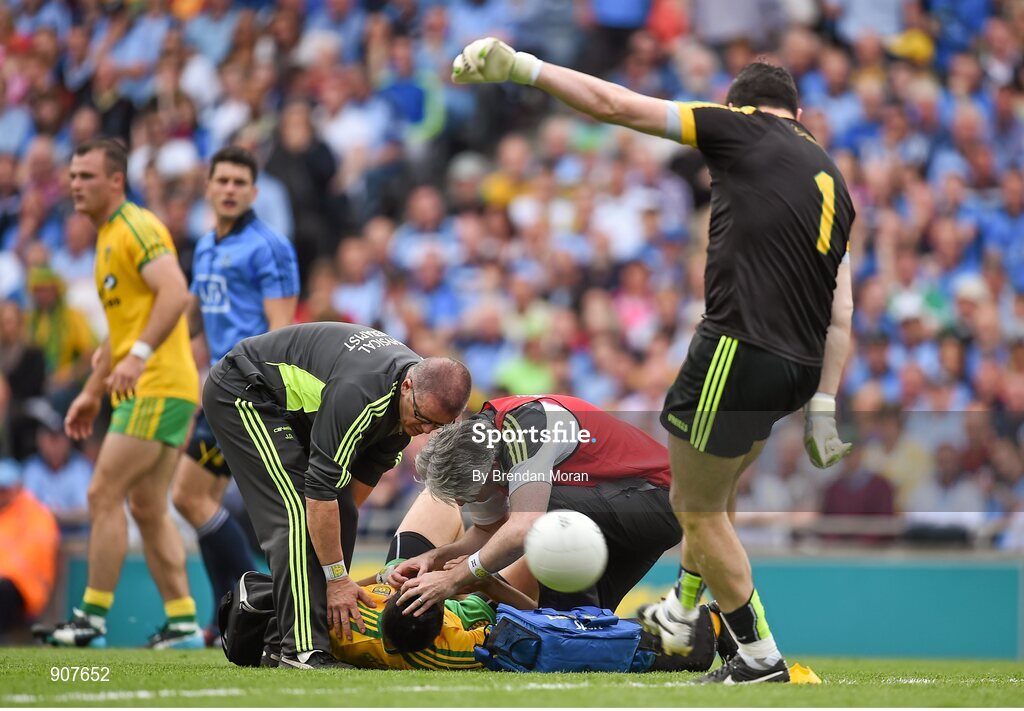 31 August 2014; Rory Kavanagh, Donegal, receives medical attention while his goalkeeper Paul Durcan takes a kick out. GAA Football All Ireland Senior Championship, Semi-Final, Dublin v Donegal, Croke Park, Dublin. Picture credit: Brendan Moran / SPORTSFILE
