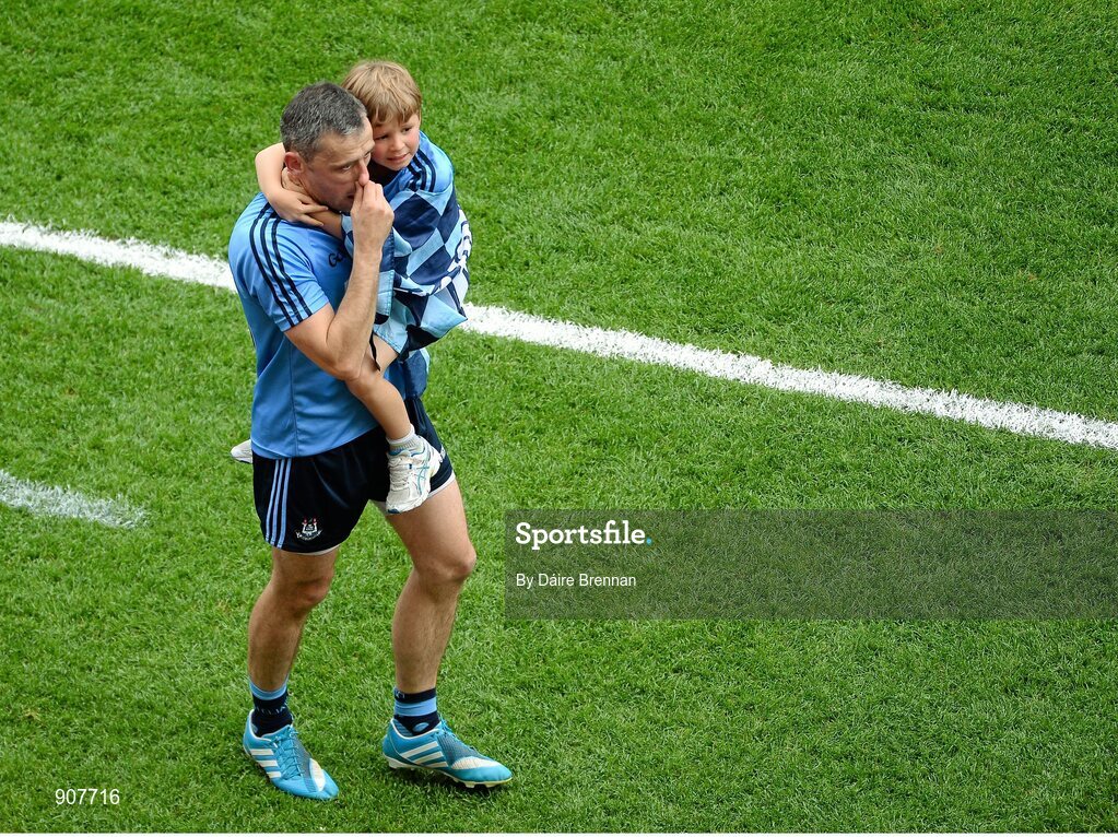 31 August 2014; A dejected Alan Brogan, Dublin, leaves the field with his son Jamie after the game. GAA Football All Ireland Senior Championship, Semi-Final, Dublin v Donegal, Croke Park, Dublin. Picture credit: Dáire Brennan / SPORTSFILE