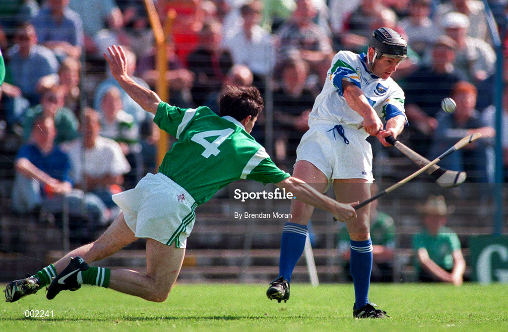 25 May 1997; Billy O'Sullivan of Waterford has a shot blocked by Declan Nash of Limerick during the Munster Senior Hurling Championship Quarter-Final between Limerick and Waterford at Semple Stadium in Thurles, Co. Tipperary. Photo by Brendan Moran/Sportsfile