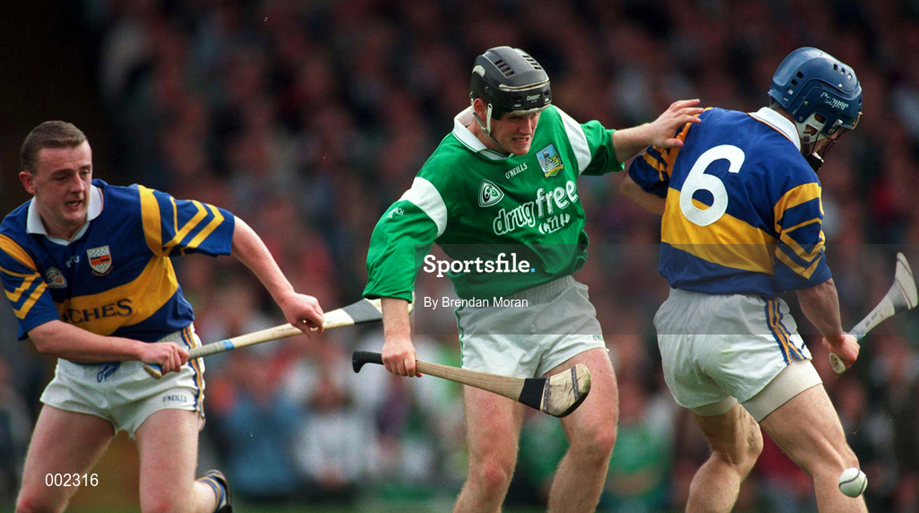 13 April 1997; Brian Tobin of Limerick in action against Colm Bonner and Stephen Hogan of Tipperary during the National Hurling League Division 1 match between Limerick v Tipperary at the Gaelic Grounds in Limerick. Photo by Brendan Moran/Sportsfile