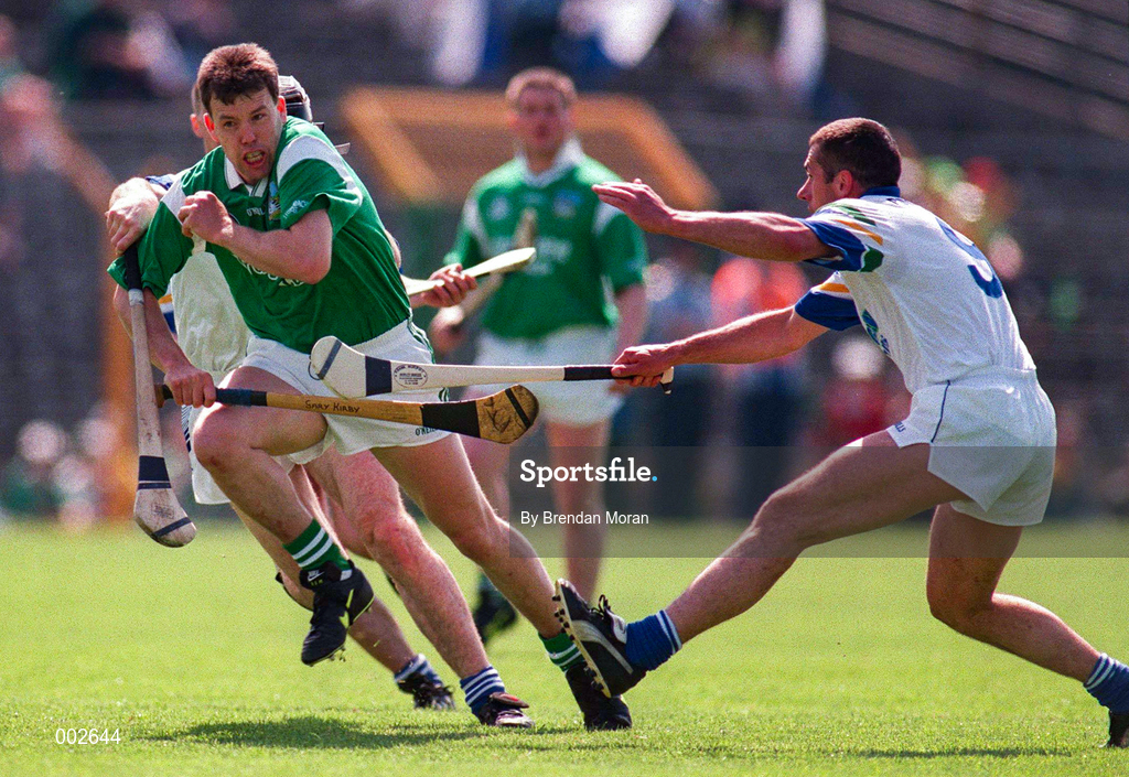 25 May 1997; Gary Kirby of Limerick in action against Peter Queally of Waterford during the Munster Senior Hurling Championship Quarter-Final between Limerick and Waterford at Semple Stadium in Thurles, Co. Tipperary. Photo by Brendan Moran/Sportsfile