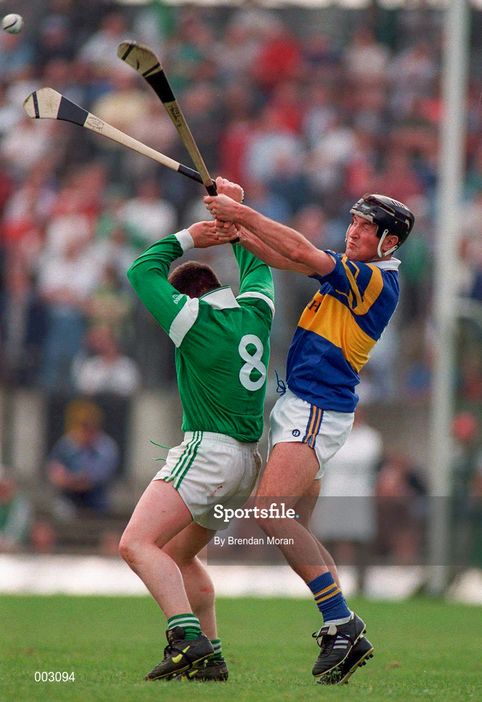 13 April 1997; Mike Houlihan of Limerick in action against Brendan Carroll of Tipperary during the National Hurling League Division 1 match between Limerick v Tipperary at the Gaelic Grounds in Limerick. Photo by Brendan Moran/Sportsfile